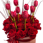 Pink tulips and red roses in a luxury round flower box with ribbon – romantic Valentine's Day floral gift delivery in Lebanon.